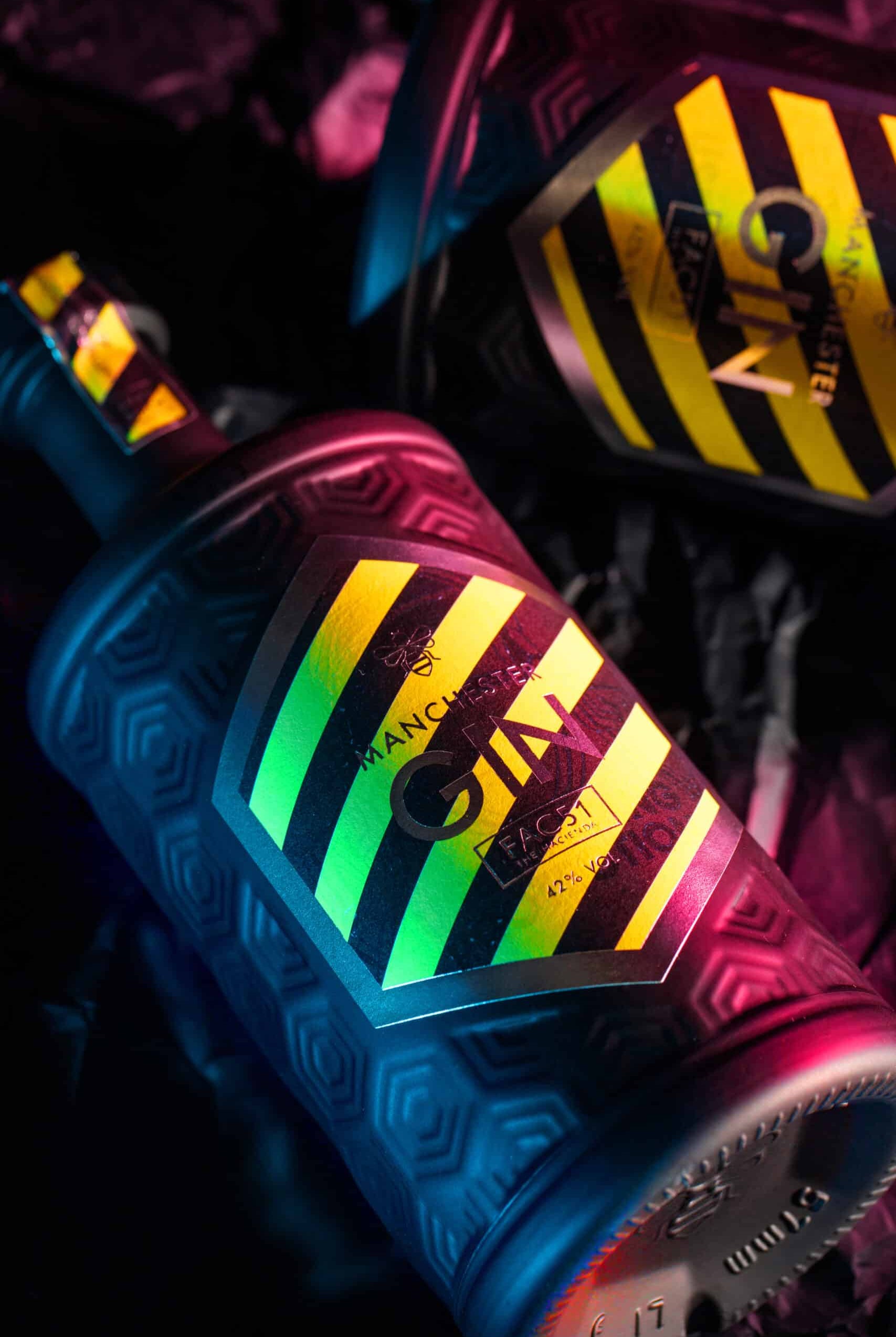 Limited Edition Haçienda Gin bottle featuring vibrant yellow and black design, crafted in Manchester.