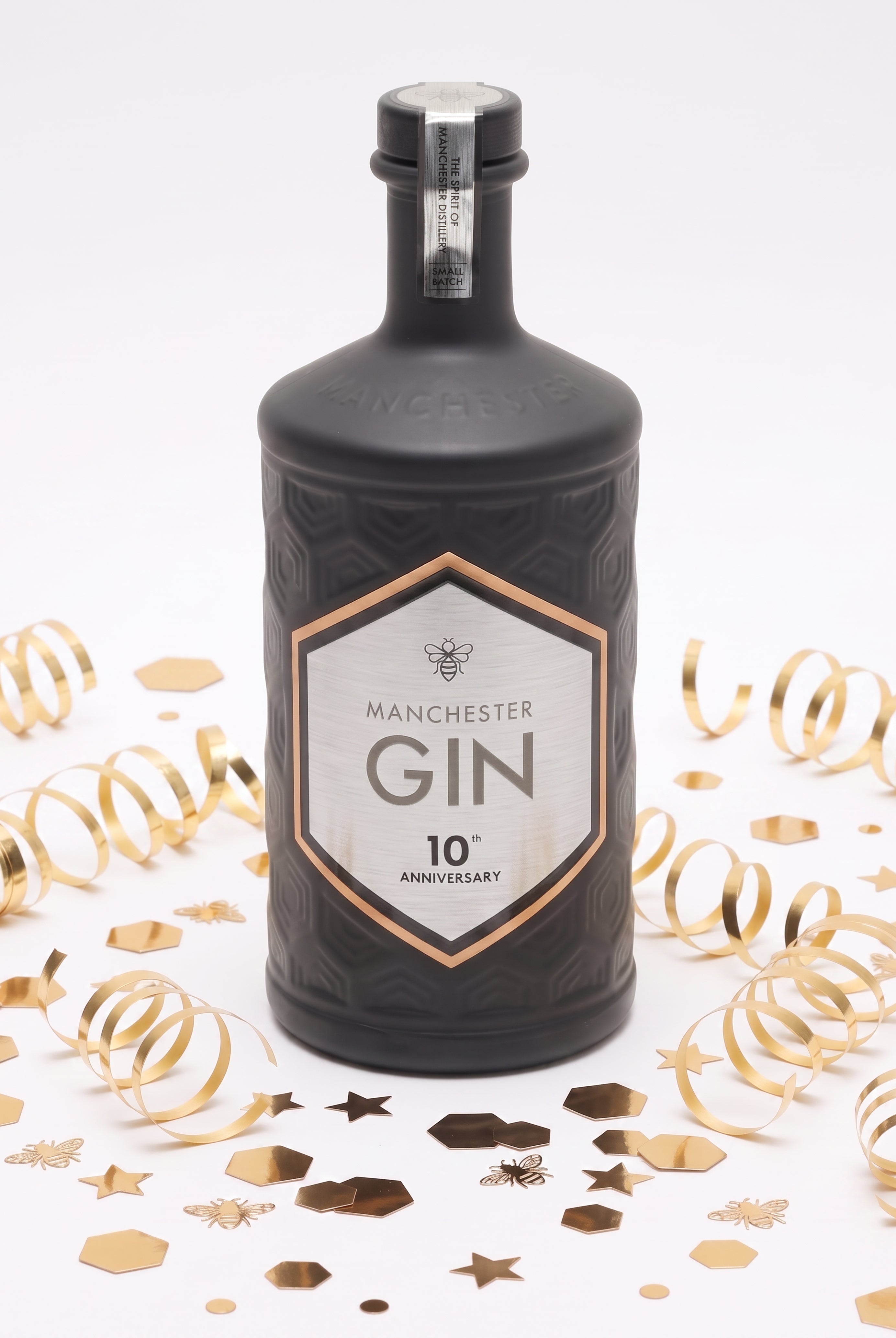 Manchester Gin 10th Anniversary Edition bottle with metallic anniversary label celebrating 10 years of distilling