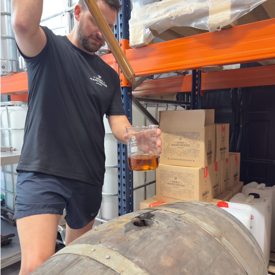 Seb Heeley checking Manchester Rum ageing barrels at The Spirit of Manchester Distillery