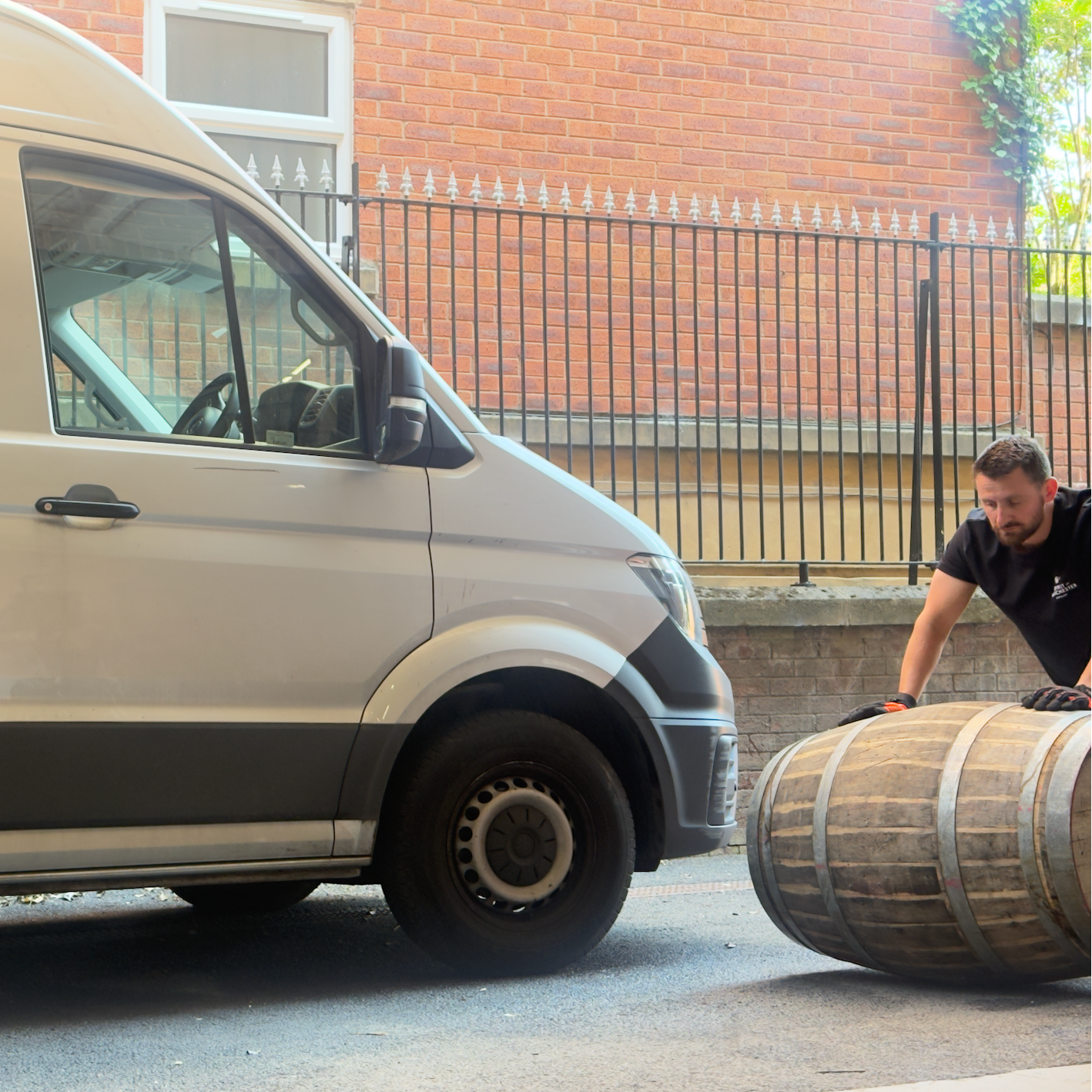 Seb rolling a barrel into the Spirit of Manchester Distillery